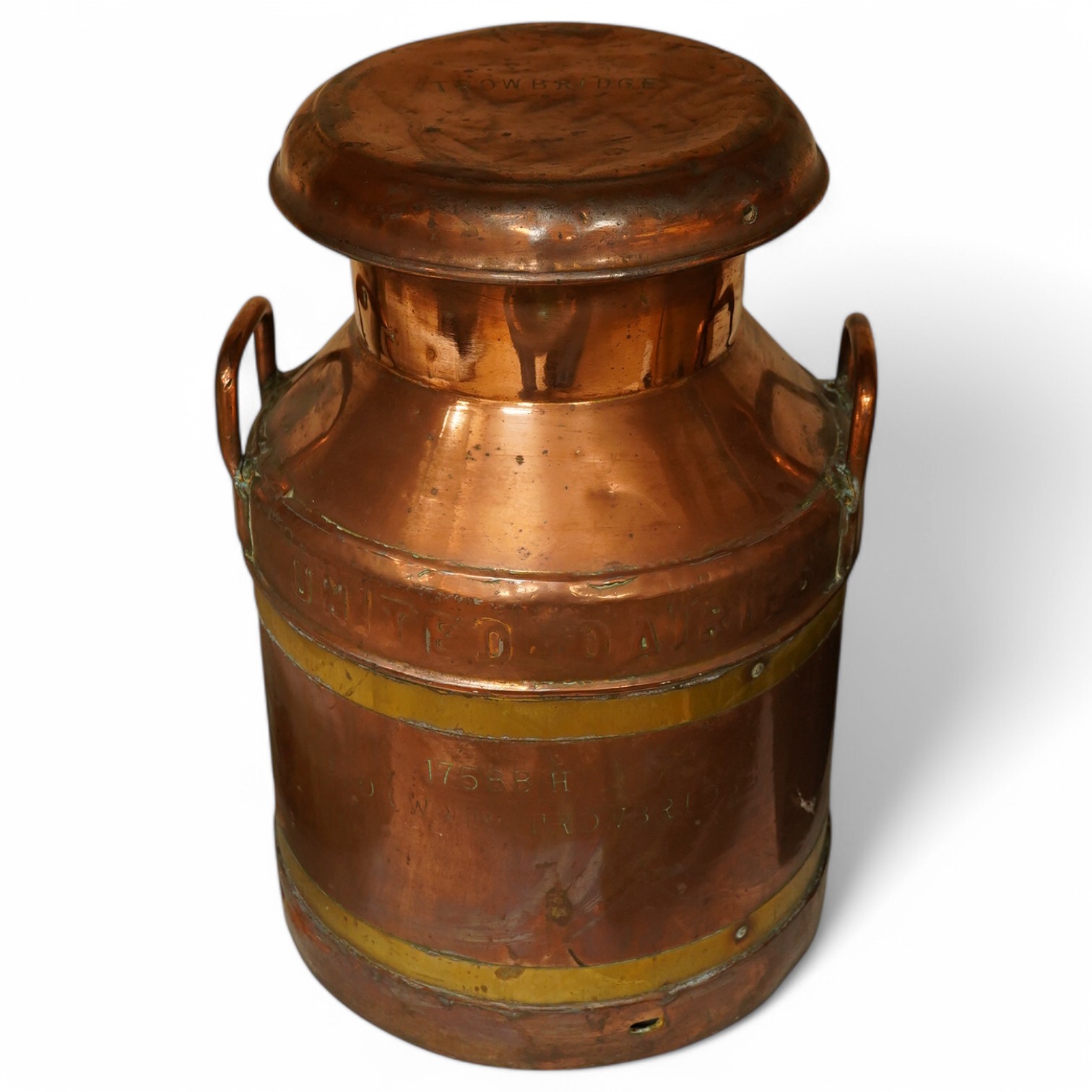 A United Dairies copper and brass banded milk churn, 52cm high. Condition - fair to good